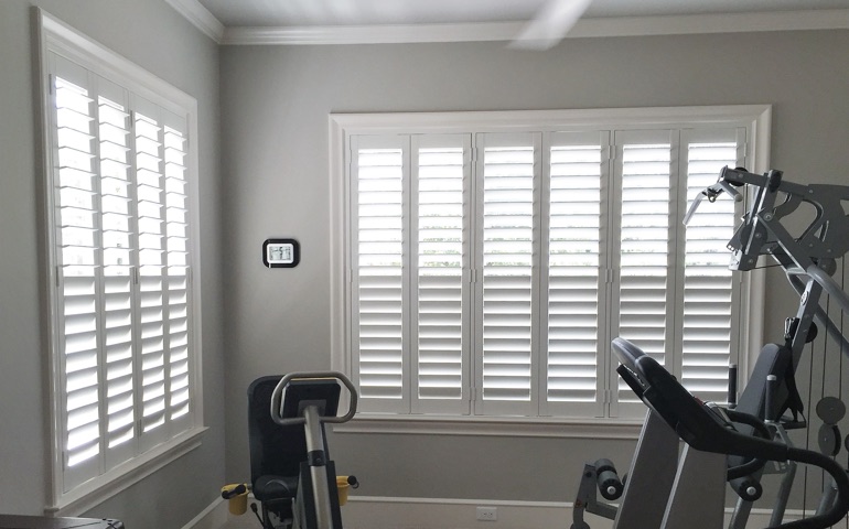 Dallas exercise room with shuttered windows.